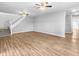 Living room with hardwood floors, staircase, and ceiling fans at 320 W 6Th St, Muncie, IN 47302