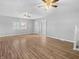 Large living room featuring hardwood floors and two ceiling fans at 320 W 6Th St, Muncie, IN 47302