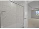 Modern bathroom showcasing a tiled shower with a sliding glass door at 4183 Douro Trl, Westfield, IN 46062