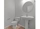 Modern bathroom with a stylish pedestal sink and round mirror at 4183 Douro Trl, Westfield, IN 46062