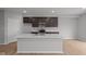 Kitchen features modern cabinets, a center island with sink, and an open layout to the living area at 4183 Douro Trl, Westfield, IN 46062