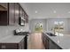 Kitchen featuring dark cabinets, an island with sink, stainless steel appliances, and an open concept at 4183 Douro Trl, Westfield, IN 46062