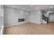 Living room with wood floors, modern fireplace, staircase, and neutral tones, creating a cozy atmosphere at 4183 Douro Trl, Westfield, IN 46062