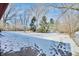 Large backyard with mature trees and patchy snow cover at 4820 E 70Th St, Indianapolis, IN 46220