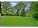 Large backyard featuring expansive lawn area and mature trees, providing ample space and a park-like feel at 4820 E 70Th St, Indianapolis, IN 46220