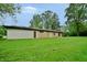 Expansive backyard featuring lush lawn and mature trees, offering privacy and space for outdoor activities at 4820 E 70Th St, Indianapolis, IN 46220