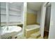 Bathroom with built-in shelves, bathtub and sink at 4820 E 70Th St, Indianapolis, IN 46220