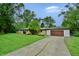 Charming ranch-style home with attached garage, a long drive, and well-maintained landscaping at 4820 E 70Th St, Indianapolis, IN 46220