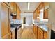 Bright kitchen with oak cabinets, granite countertops, and stainless steel appliances at 4820 E 70Th St, Indianapolis, IN 46220