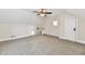 Spacious attic bedroom with neutral carpeting and ceiling fan at 4992 W 100 S, New Palestine, IN 46163