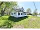 Two-story home featuring green trim, mature trees, and a green lawn at 4992 W 100 S, New Palestine, IN 46163