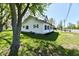 Well-maintained two-story home with green trim and mature trees in a well-manicured yard at 4992 W 100 S, New Palestine, IN 46163