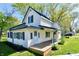 Attractive two-story home with a side porch, white siding, and well-kept landscaping at 4992 W 100 S, New Palestine, IN 46163