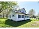 Two-story home with green shutters, mature trees, and a lush green lawn at 4992 W 100 S, New Palestine, IN 46163