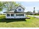 Charming two-story home with white siding, green shutters, and a well-maintained lawn at 4992 W 100 S, New Palestine, IN 46163