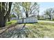 Detached garage with multi-door access surrounded by mature trees on a partially shaded lawn at 4992 W 100 S, New Palestine, IN 46163