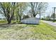 Detached garage with multi-door access surrounded by mature trees and lush, green grass at 4992 W 100 S, New Palestine, IN 46163