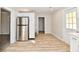 Modern kitchen with white cabinets, stainless steel appliances, and light wood flooring at 4992 W 100 S, New Palestine, IN 46163