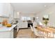 Modern kitchen with white cabinets, stainless steel appliances, and dining area at 4992 W 100 S, New Palestine, IN 46163