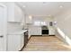 Modern kitchen with white cabinets, stainless steel appliances, and light wood flooring at 4992 W 100 S, New Palestine, IN 46163