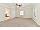 Living room with carpet flooring, ceiling fan and views of the kitchen at 4992 W 100 S, New Palestine, IN 46163