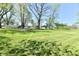 Expansive lawn with mature trees and detached garage surrounding a vinyl sided home at 4992 W 100 S, New Palestine, IN 46163