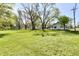 Expansive lawn with mature trees surrounding a home with vinyl siding on a sunny day at 4992 W 100 S, New Palestine, IN 46163
