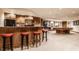 Basement bar with red stools and wood cabinetry at 5101 Green Braes E Dr, Indianapolis, IN 46234