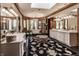Opulent bathroom with a freestanding tub, dual vanities, and a large chandelier at 5101 Green Braes E Dr, Indianapolis, IN 46234