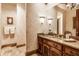 Relaxing bathroom with a vanity, large mirror, and decorative wallpaper at 5101 Green Braes E Dr, Indianapolis, IN 46234