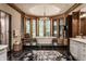 Stunning bathroom with a soaking tub, dual vanities and black flooring at 5101 Green Braes E Dr, Indianapolis, IN 46234