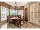 Charming breakfast nook with floral chairs and a round table, offering ample natural light at 5101 Green Braes E Dr, Indianapolis, IN 46234