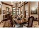 Spacious dining room showcasing a large wooden table and a stunning chandelier at 5101 Green Braes E Dr, Indianapolis, IN 46234