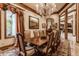 Formal dining room with a rich wooden table and chandelier, views into the living room at 5101 Green Braes E Dr, Indianapolis, IN 46234