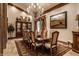 Elegant dining room featuring a large table, chandelier, and ornate rug at 5101 Green Braes E Dr, Indianapolis, IN 46234