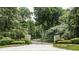 Ornate iron gate opens to a tree-lined driveway at 5101 Green Braes E Dr, Indianapolis, IN 46234