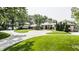 Stunning home with circular driveway, landscaping, and mature trees at 5101 Green Braes E Dr, Indianapolis, IN 46234