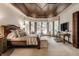 Spacious main bedroom with a king-size bed and a large TV at 5101 Green Braes E Dr, Indianapolis, IN 46234