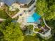 Aerial view of rectangular pool, landscaping, and stone patios at 5101 Green Braes E Dr, Indianapolis, IN 46234
