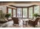 Relaxing sunroom with wicker furniture and lake view at 5101 Green Braes E Dr, Indianapolis, IN 46234