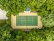 Private tennis court nestled in a wooded area at 5101 Green Braes E Dr, Indianapolis, IN 46234