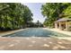 Private tennis court nestled among lush trees at 5101 Green Braes E Dr, Indianapolis, IN 46234