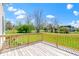 View of a home's back porch featuring wood floors, railing, and a yard at 5420 Mcfarland Rd, Indianapolis, IN 46227