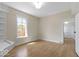 Bright bedroom featuring light-colored walls, a large window, and hardwood floors at 5420 Mcfarland Rd, Indianapolis, IN 46227