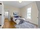 Cozy bedroom featuring natural light from a window, wood floors, and a decorative rug at 5420 Mcfarland Rd, Indianapolis, IN 46227