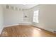 Bedroom with built-in shelving, hardwood floors, and a window at 5420 Mcfarland Rd, Indianapolis, IN 46227