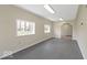 Spacious bonus room featuring bright natural light and an arched entry way leading to another room at 5420 Mcfarland Rd, Indianapolis, IN 46227