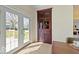 Dining room with a deck view through glass doors and a built-in china cabinet at 5420 Mcfarland Rd, Indianapolis, IN 46227