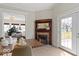 Dining room with a fireplace, a view of the living room, and deck access through glass doors at 5420 Mcfarland Rd, Indianapolis, IN 46227