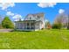 Beautiful home featuring a screened porch, complemented by a lush green lawn and mature trees at 5420 Mcfarland Rd, Indianapolis, IN 46227